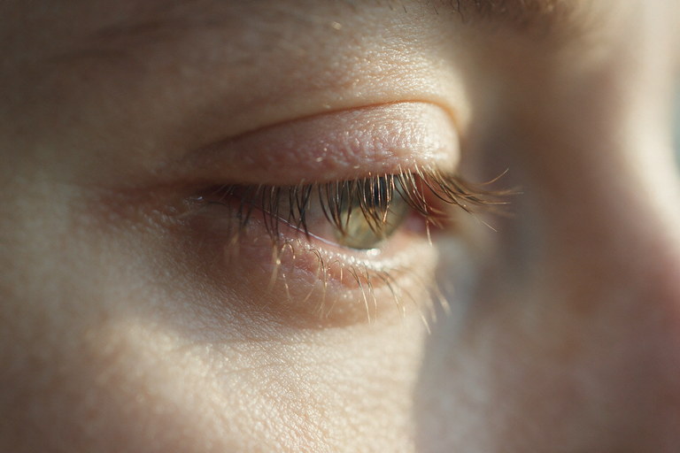 Close-up of a closed eyelid and lashes during an eyelid twitch